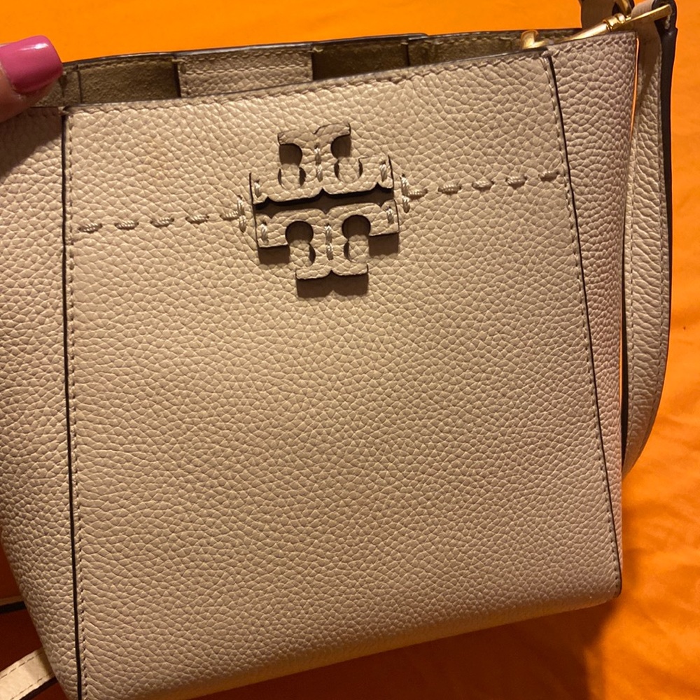 Tori Burch MCGraw small bucket bag with top handle and cross body strap.